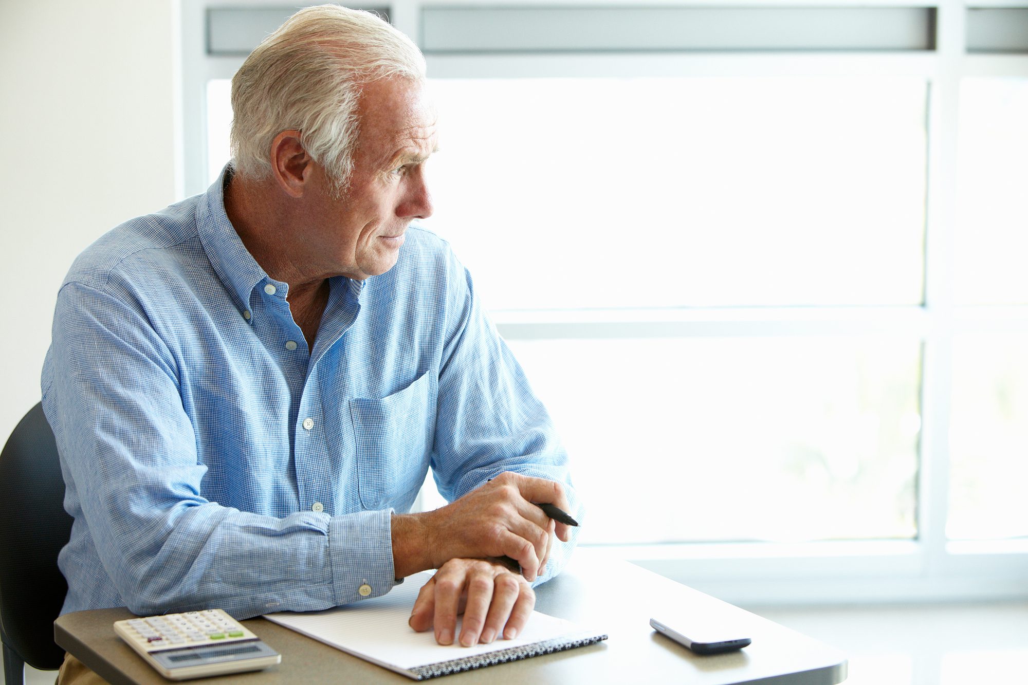 Older man thinking about new hearing aids