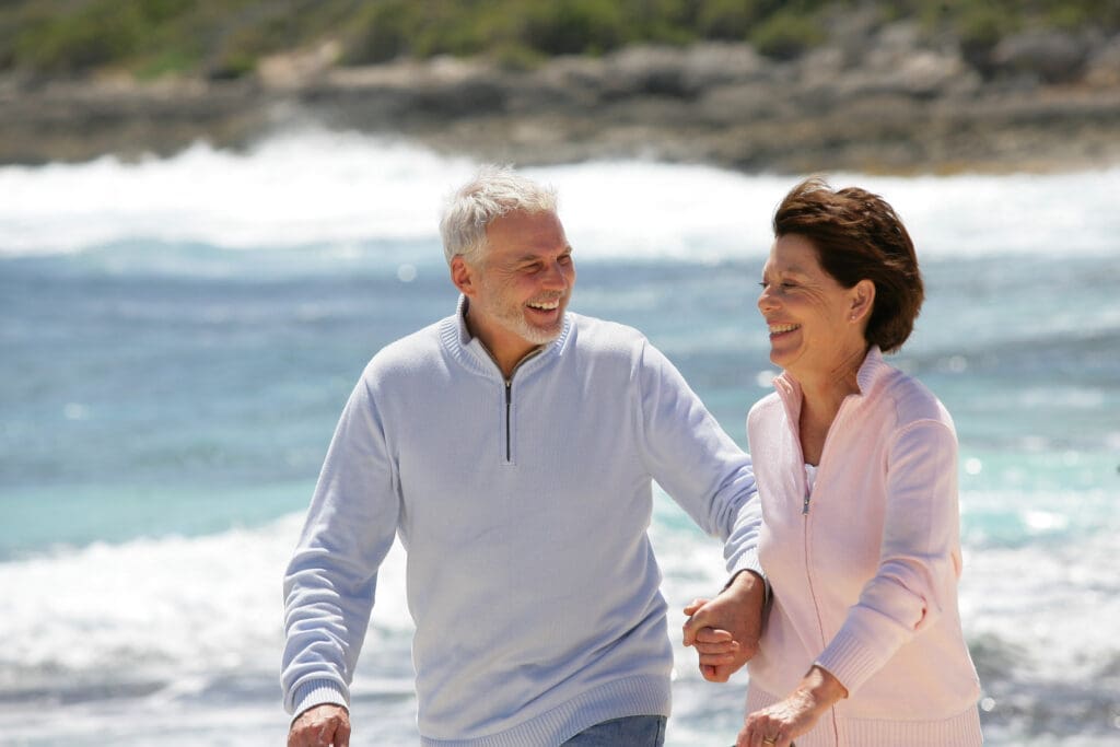 Senior couple running on the beach