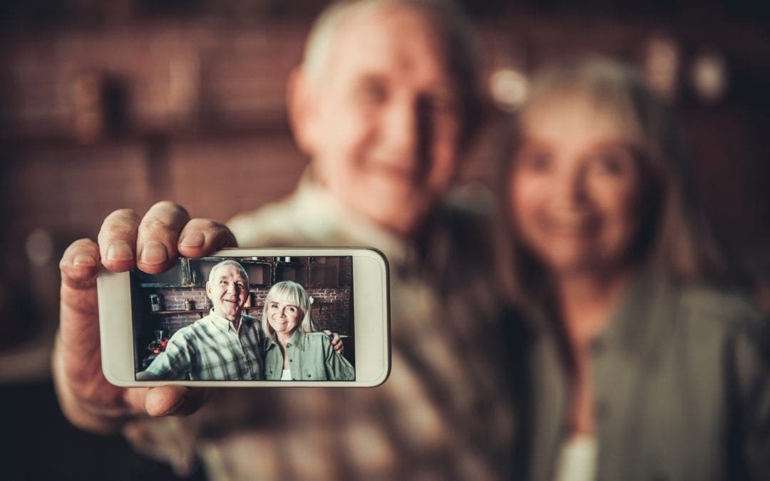 Senior Couple taking photo with smartphone